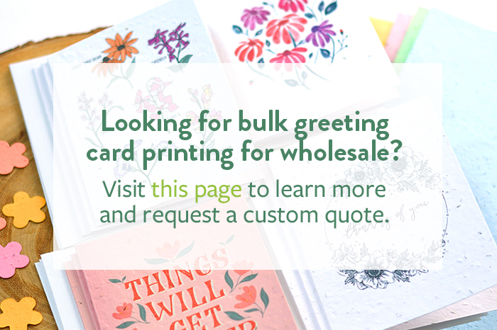 Picture with stacks of custom printed seed paper greeting cards with text to visit another page to learn about wholesale orders.